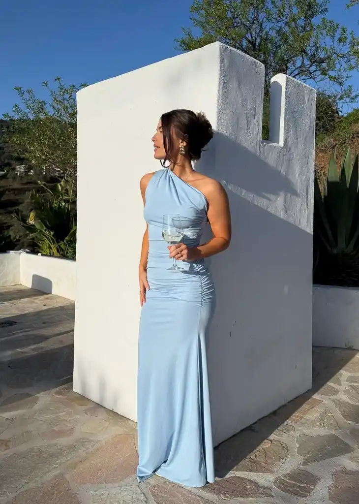 A guest in a powder blue one-shoulder satin gown